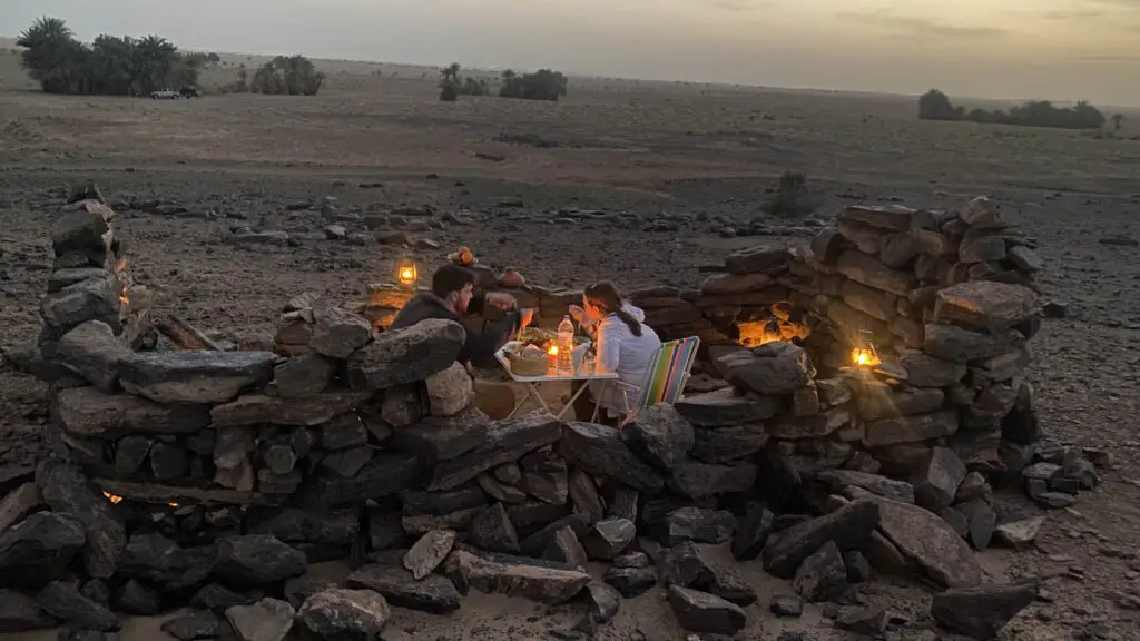 A campfire burning at dusk in the desert